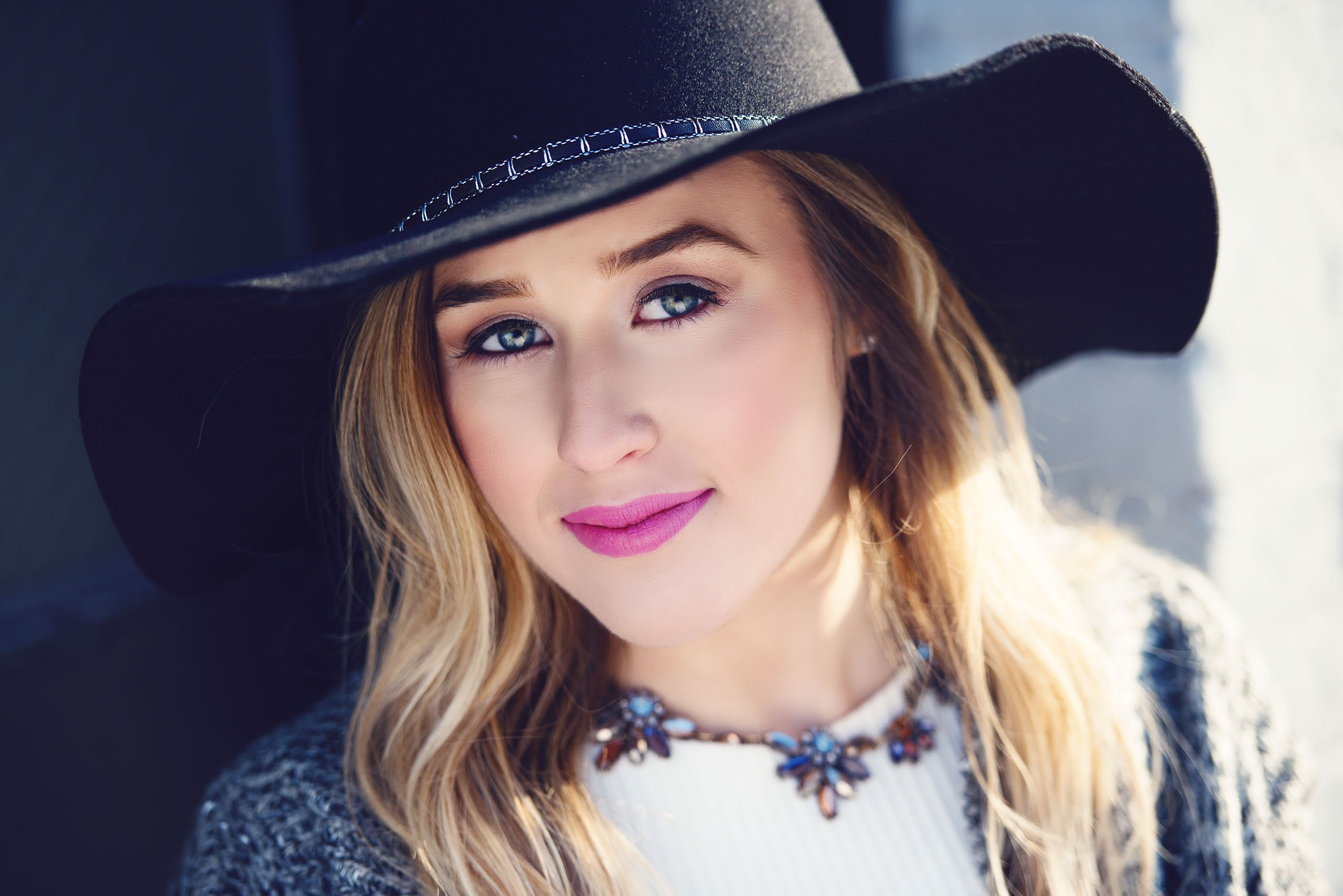 A Senior photo of Anthony Wayne High School student, Kelsey, posing with an Elephant at the Toledo Lucas County Fair.