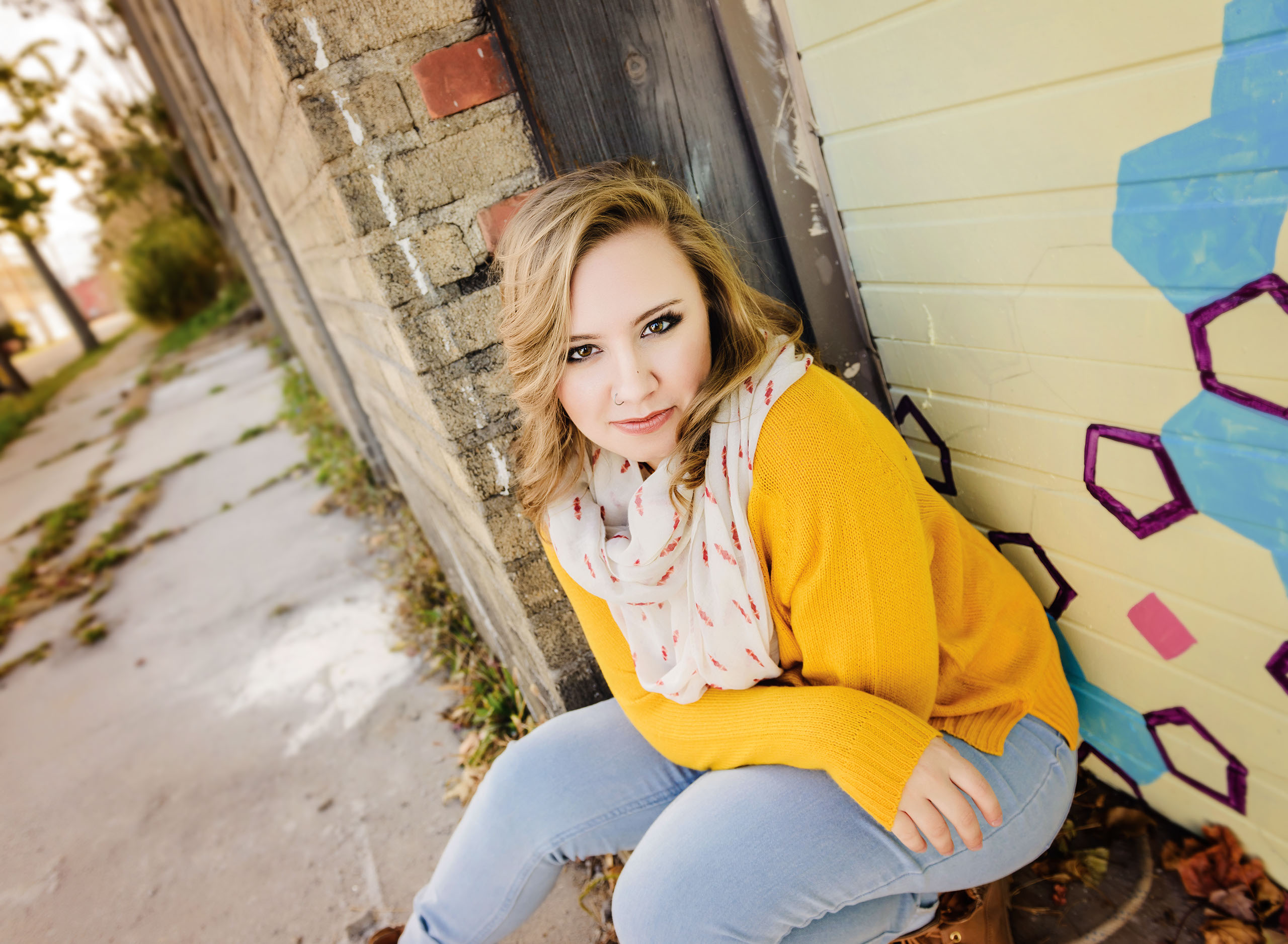 A Senior photo of Anthony Wayne High School student, Kelsey, posing with an Elephant at the Toledo Lucas County Fair.
